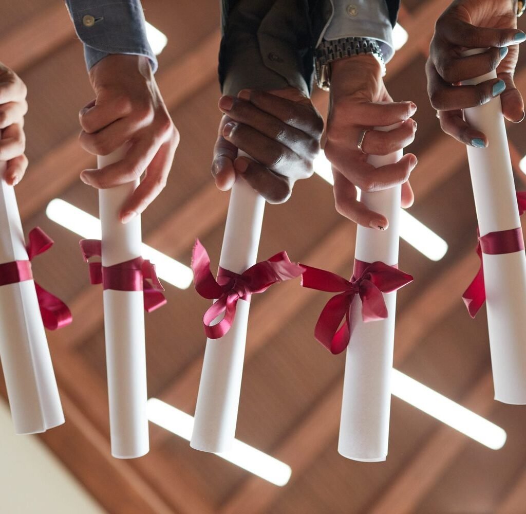 college graduates holding diplomas close up ljwng62 (1)