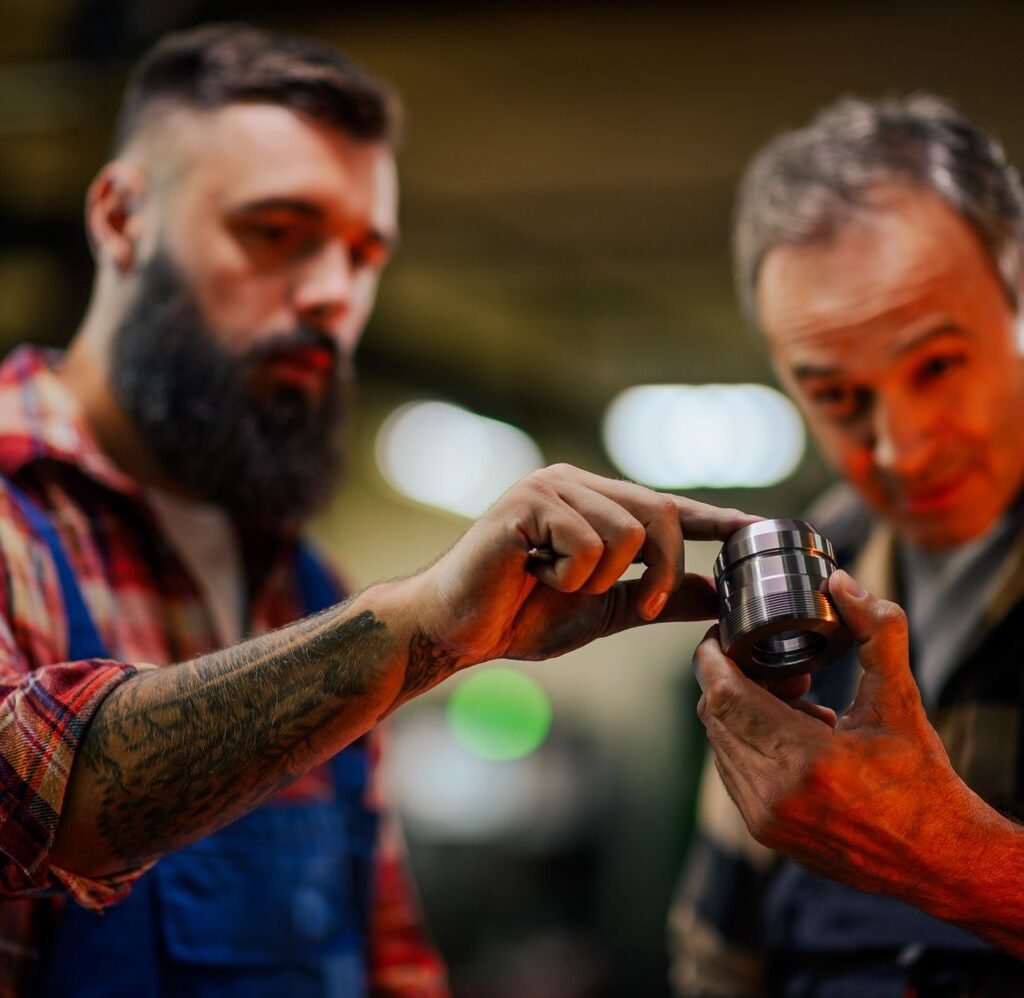 selective focus on hands examining a metal part bl zxglfhn